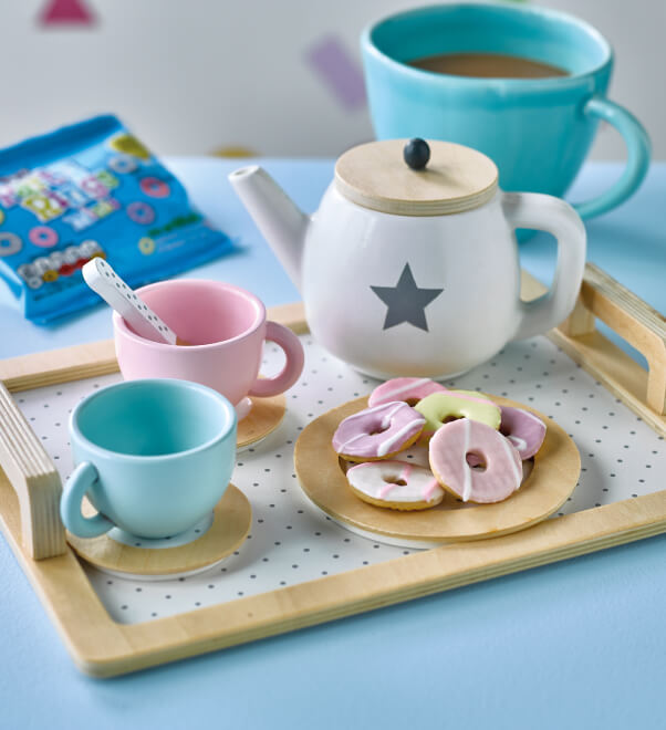 A toy tea set with a plate of mini Party Rings
